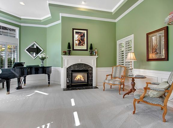 The open living room with gas fireplace and marble surround is punctuated by a