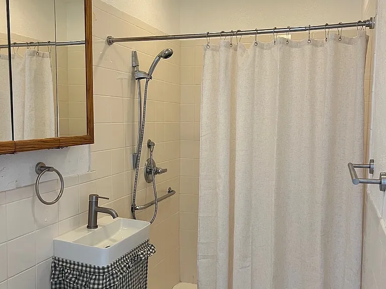 Main floor full bath, large shower and medicine cabinet. New sink and hardware.