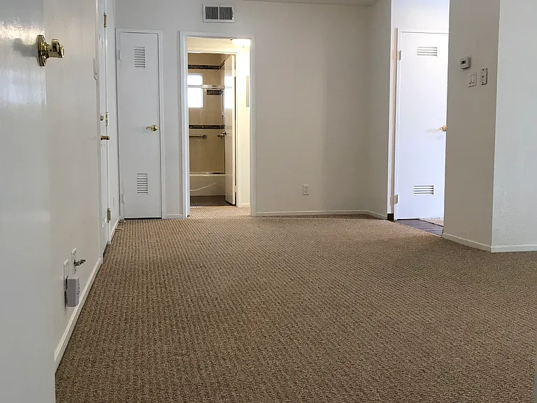 Living room, dining room and bedroom have wall-to-wall carpeting.