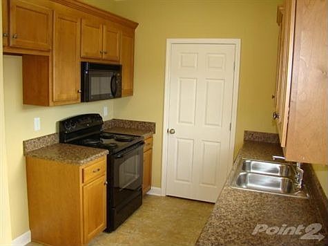 Custom Cabinetry In The Kitchen Sports Stylish Counter Tops & Brushed Nickel Hardware.