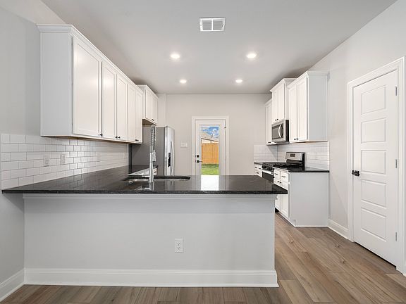 Upgraded kitchen overlooks the living room, adding convenience.