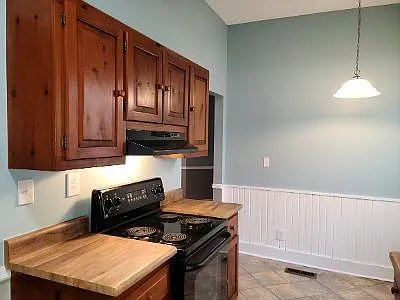 Adorable galley Kitchen with Hickory cabinets and Breakfast nook