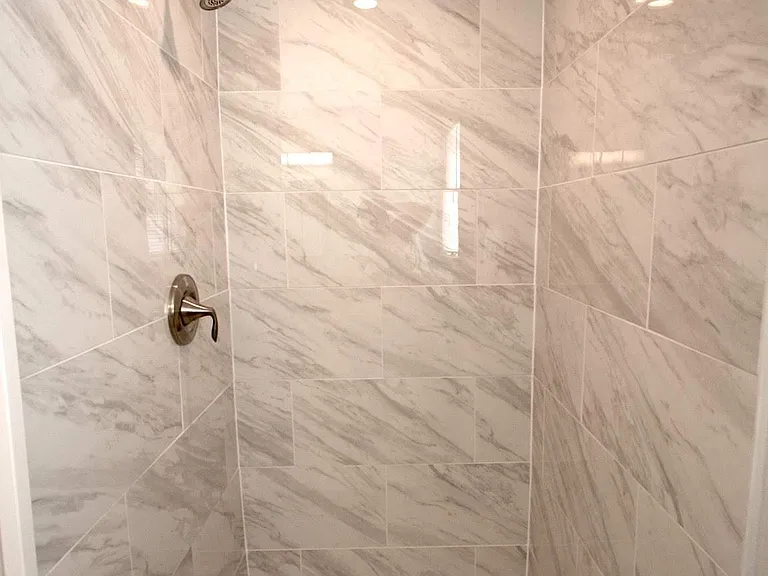 Custom tiled shower with Moen brushed nickel fixtures