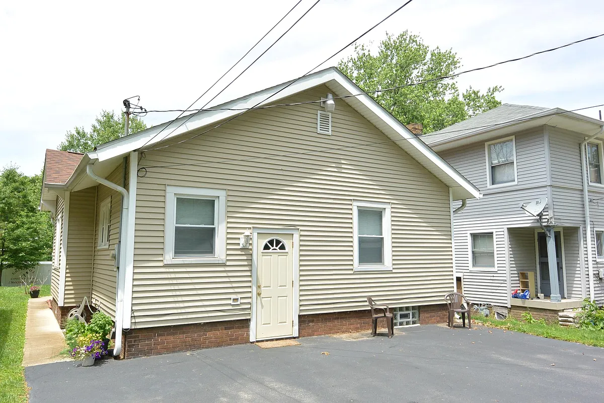 Back of house and paved parking for three cars. - 5265 N College Ave