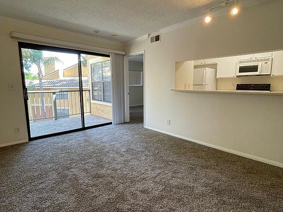Living Room & Glass Doors to Balcony. Serve through to Kitchen.