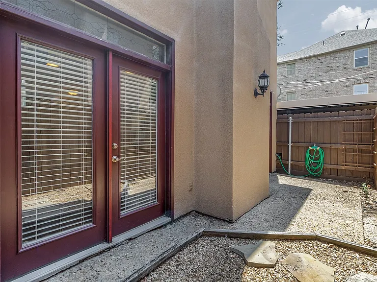 Enclosed dirt area, currently used with pea gravel.