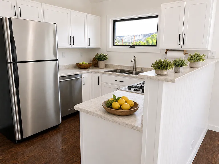 A bright, freshly updated kitchen featuring newly painted cabinetry and sleek modern hardware.