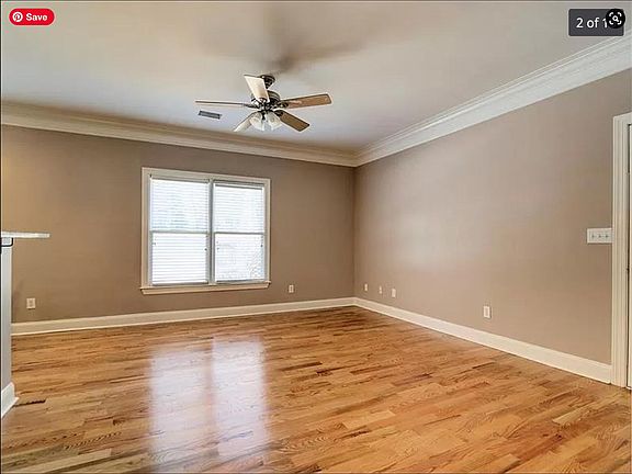 Living Room (open floor plan to kitchen). Doorway on right leads to wrap-around back porch/deck.