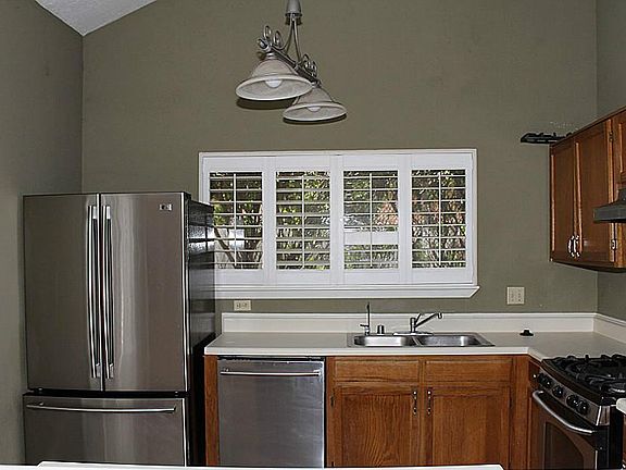Stainless appliances in kitchen with lots of windows