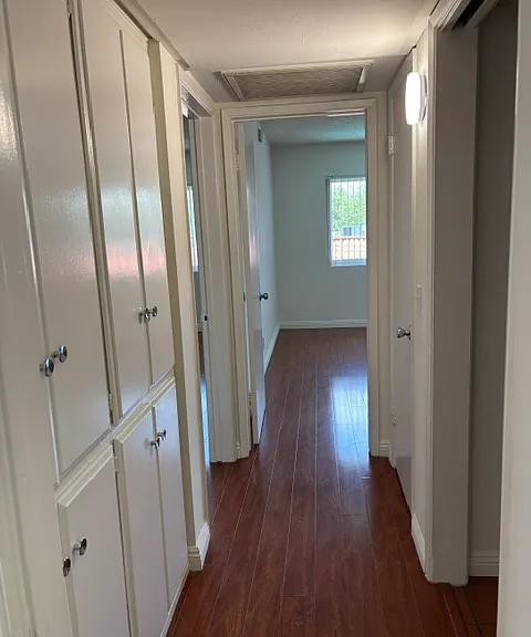 Hallway with linen closet and coat closet.