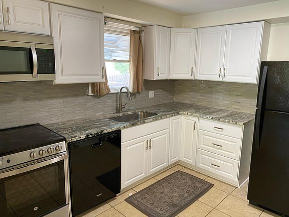 Kitchen with new marble countertops, new cabinets and backsplash