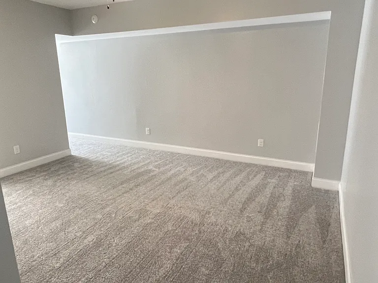 Basement level flex room with separate outdoor access and access to the finished one car garage.