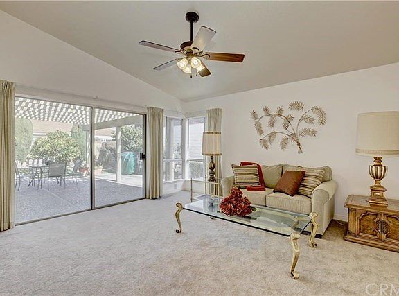 Large formal living room with sliding glass doors taking you out to the back patio