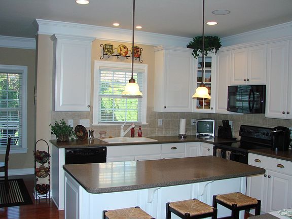 Large gourmet kitchen with corian counters, ceramic backsplash