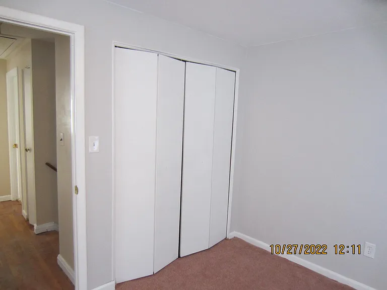 Prime bed room shows the large closet and entrance into the room. The bathroom is on the left side of the hall across from stairway which shows on the right of photo.