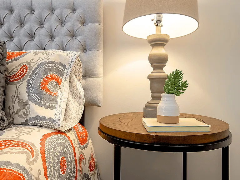 Spacious bedroom in a modern apartment featuring luxury carpeting, ample natural light, and a sleek, contemporary design for a comfortable and stylish retreat.