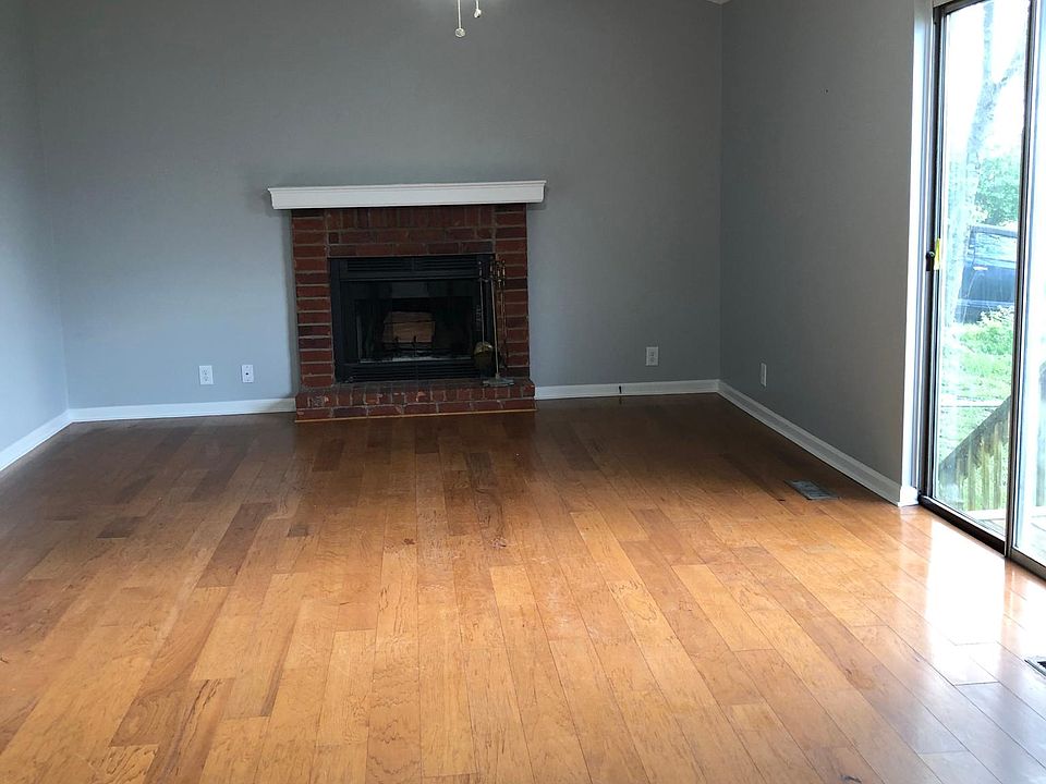 Living room portion of huge living room / dining room combo Features live fireplace & high ceilings.