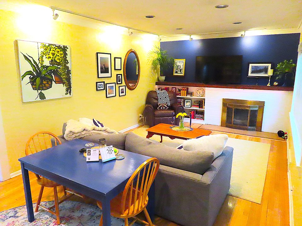 Living Room with hardwood floors, gas fireplace, large picture window facing east.