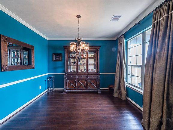Formal dining room with crown molding and wood flooring