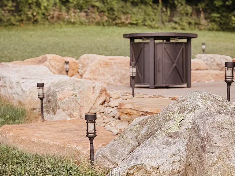 Propane fire pit with solar lighting for evenings outside