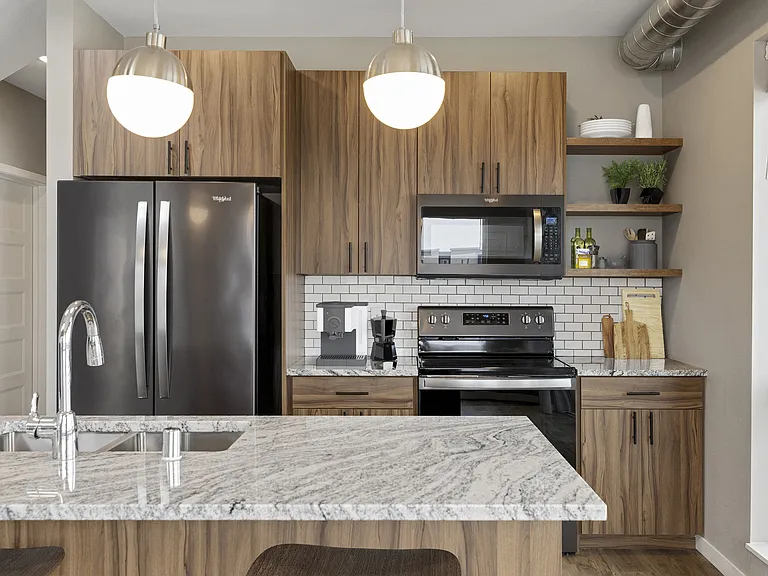 B-Level Penthouse Kitchen Featuring Black Stainless Appliances