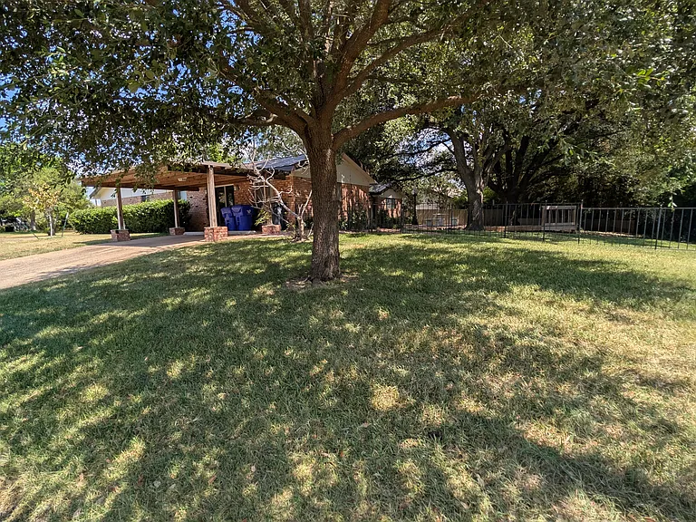 Carport opens onto Mt. Terminal Dr.
View into Iron-Fenced Backyard