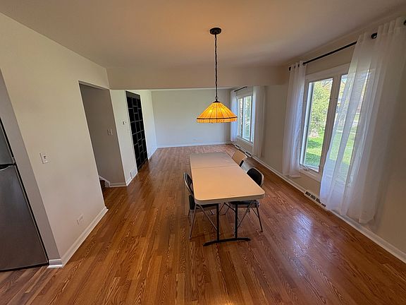 Dining room and living room combo across the front of house. Big windows.
