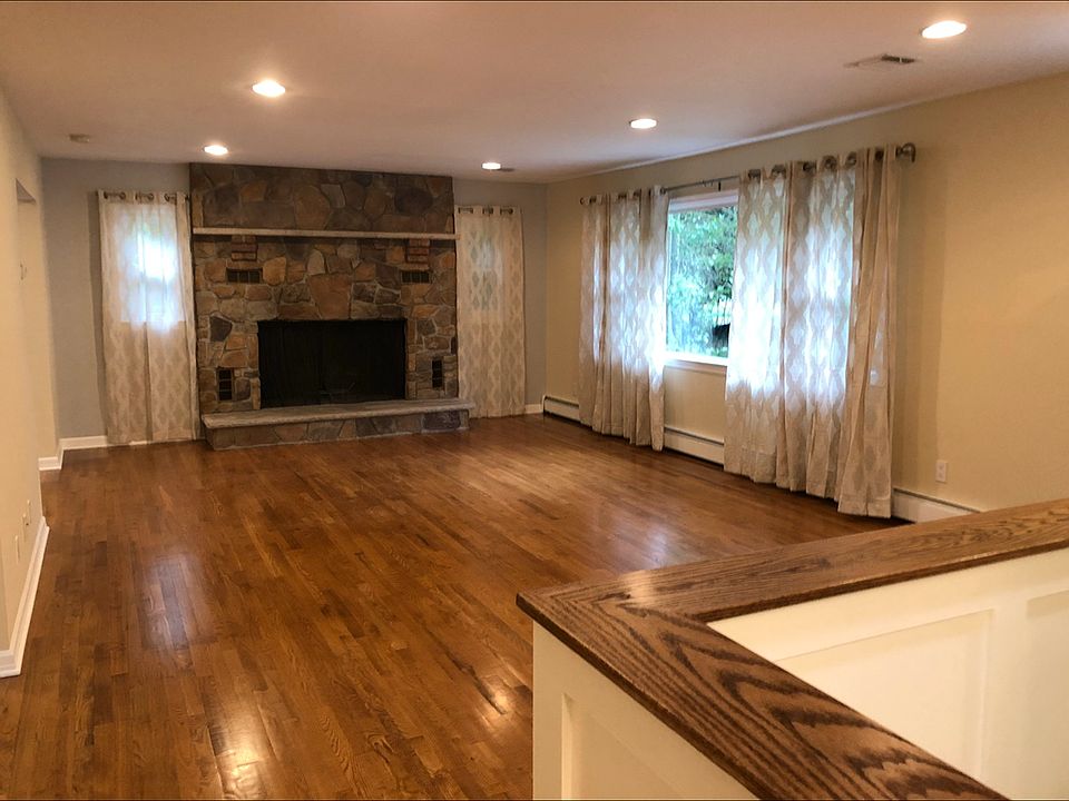 Living room with wood burning fireplace.