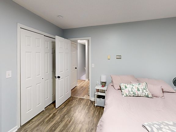 Bedroom one with large double reach-in closets. Photo is of a similar unit; available unit has the same floorplan. Furniture and decor not included.