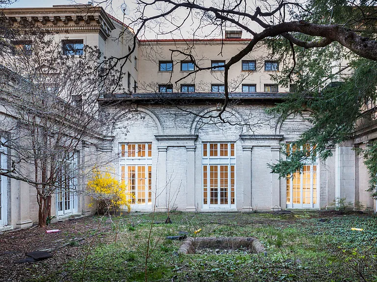 Before: Pre-renovation courtyard featuring original architectural features with gorgeous windows