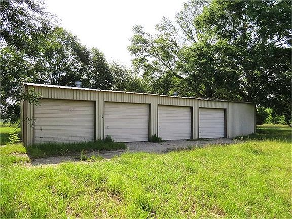 A 40 X 60 wood frame metal building with partial concrete foundation, five roll up doors and one walk through door.