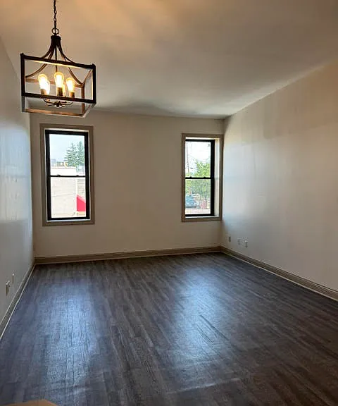Living room and dining room area. Newer flooring and windows.