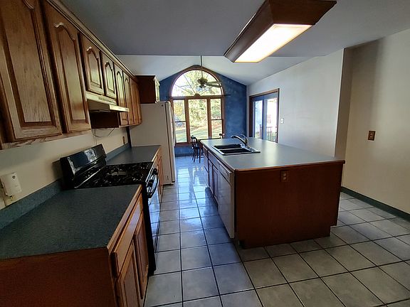 Large kitchen with island and eat in area.