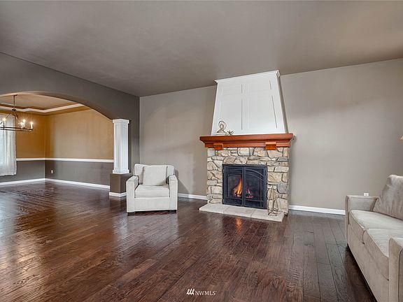 Formal living room has gas fireplace with custom masonry and woodwork