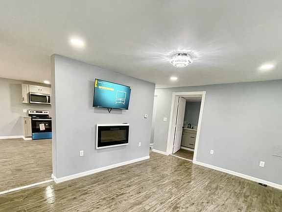 Living room, fireplace, and wall mounted TV
