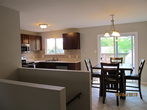 Open living, breakfast, and kitchen areas.