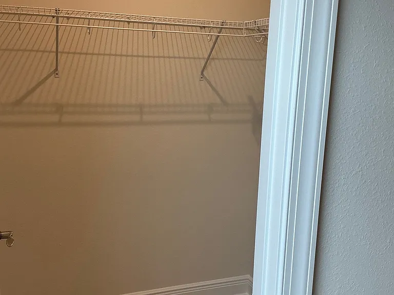 Primary bedroom walk-in closet