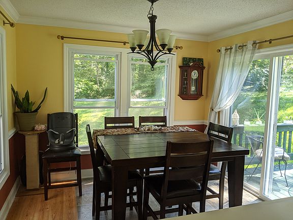 dining room is surrounded by big windows and gets beautiful natural light