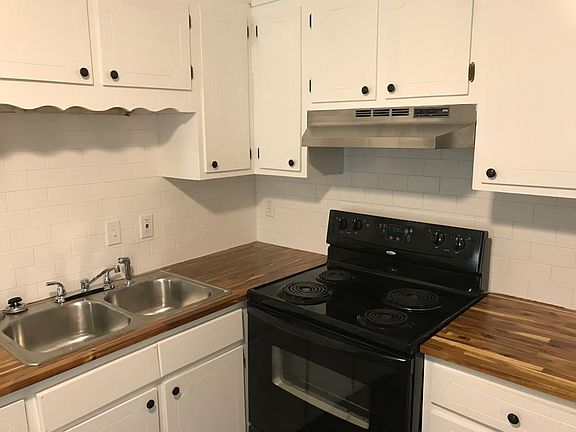 refinished cabinets, butcher block counters and subway tile