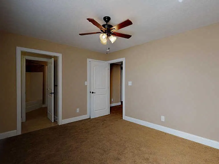 Upstairs bedroom with shared access to jack and Jill bathroom, includes individual sink and vanity space.