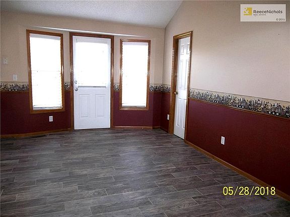 Large Dining Area open to Kitchen on left. Door in center opens to Deck with the door on right to Walk-in Pantry.
