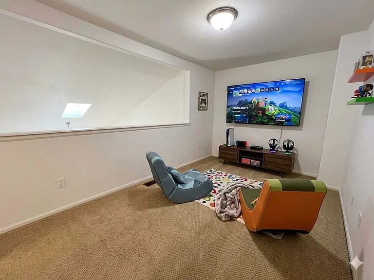 Loft area decorated by AI as if used as a TV and game room for children.
NOTE: House is unfurnished.