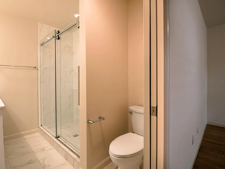 Gorgeous walk-in shower with glass doors.