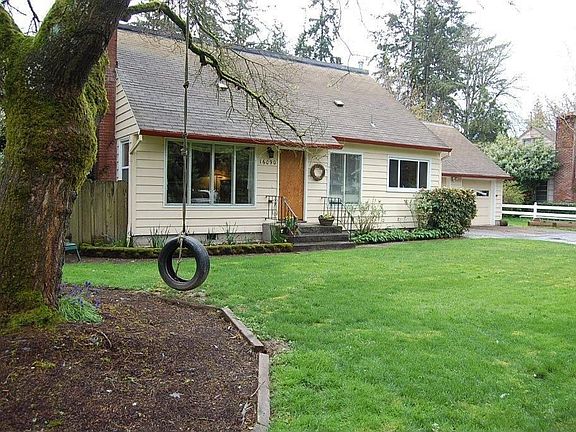 Front of house from tree swing in large locust tree