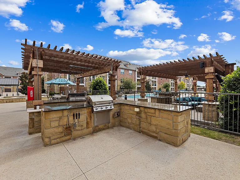 Enjoy outdoor cooking and poolside gatherings at Auberge of Burleson, a luxury apartment community in Burleson, Texas.