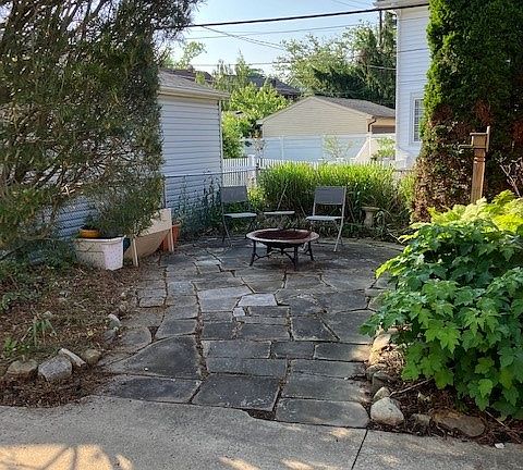 Lanscaped rear sandstone patio