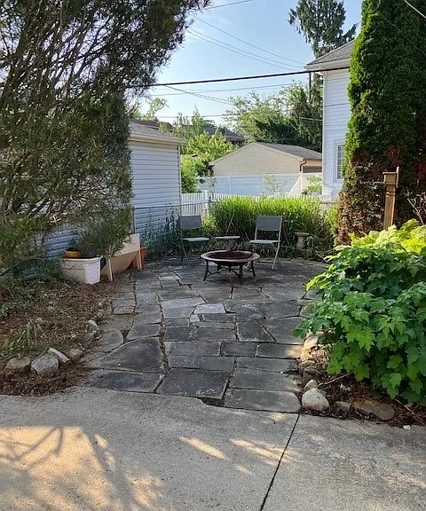 Lanscaped rear sandstone patio