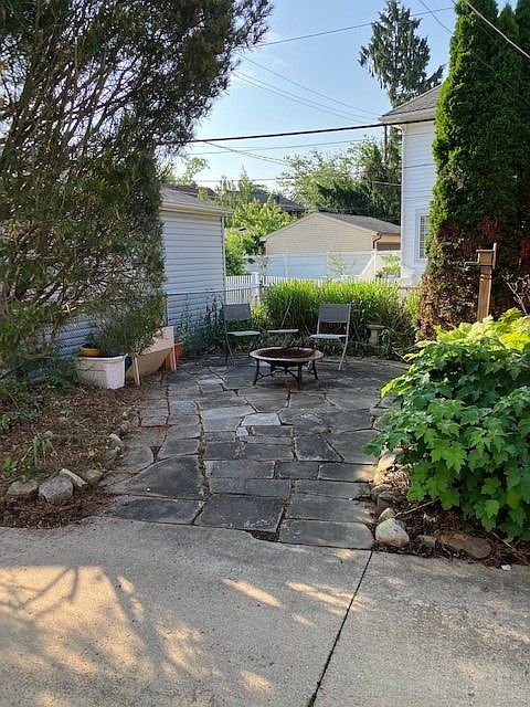 Lanscaped rear sandstone patio