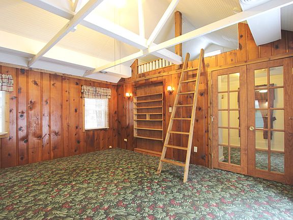 Glass French Doors Leading to Bedroom, Rustic Wood Paneling & Maintenance Free Vinyl Windows