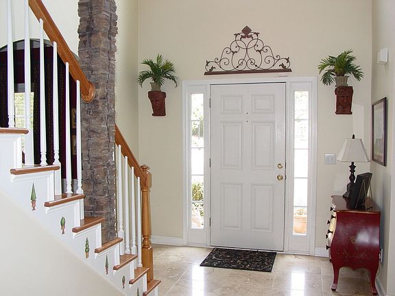 Two Story Foyer w/ Tile Floors.